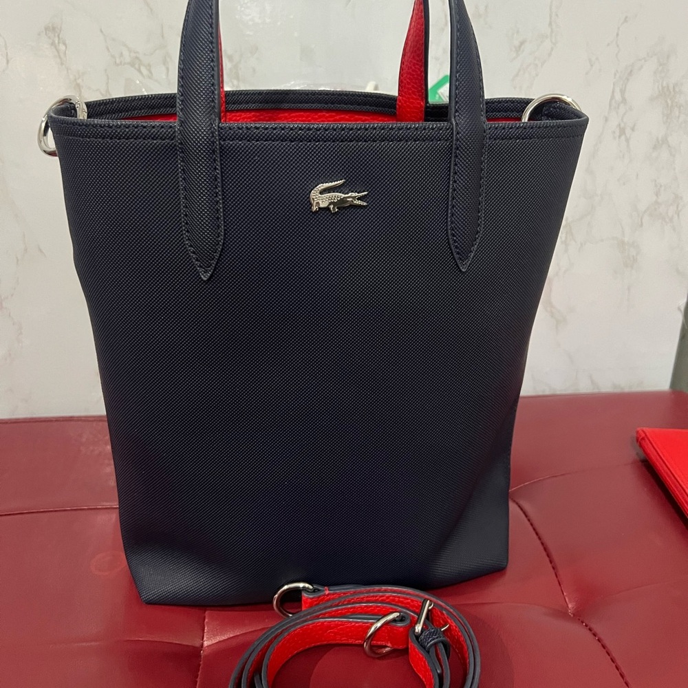 Lacoste Navy/red reversible tote with sling strap and pouch.